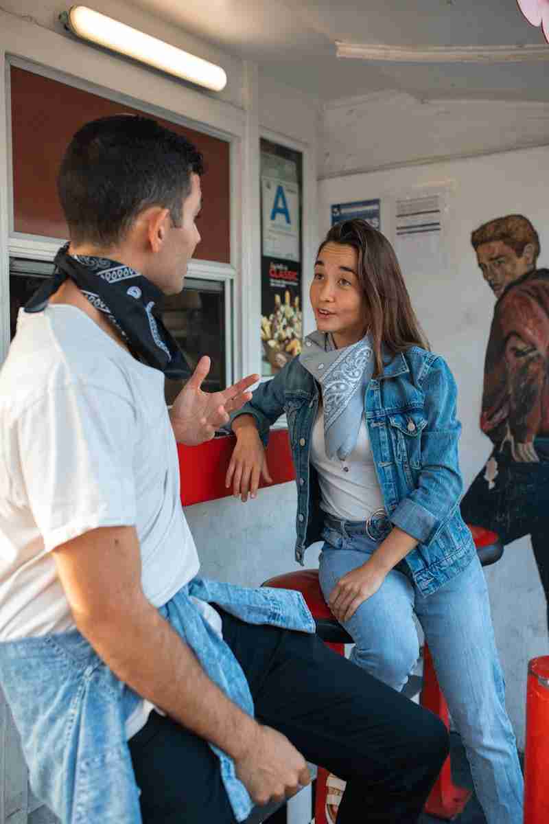 couple talking on Stools of a Food Stall