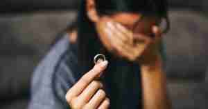 woman holding wedding ring