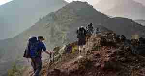 people hiking up a mountain