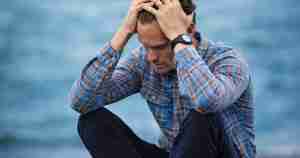 stressed married man sitting by the water