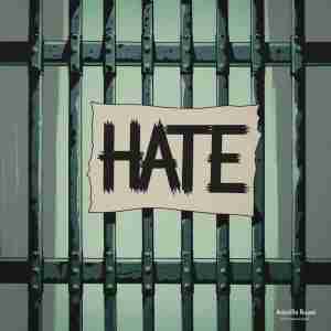 the word hate posted to an iron fence