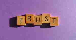 trust spelled out in scrabble cubes