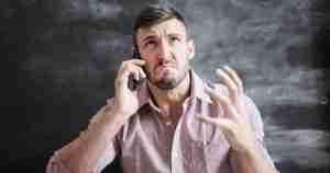 upset man talking on a phone