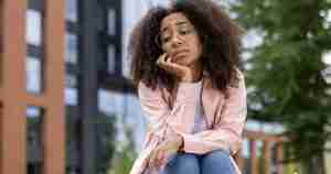 sad or bored woman sitting outdoors