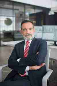 arms crossed unconvinced man wearing a business suit