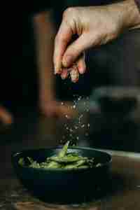 sprinkling salt on cooking