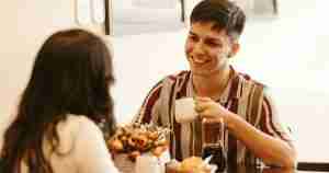 woman and man talking and drinking coffee together