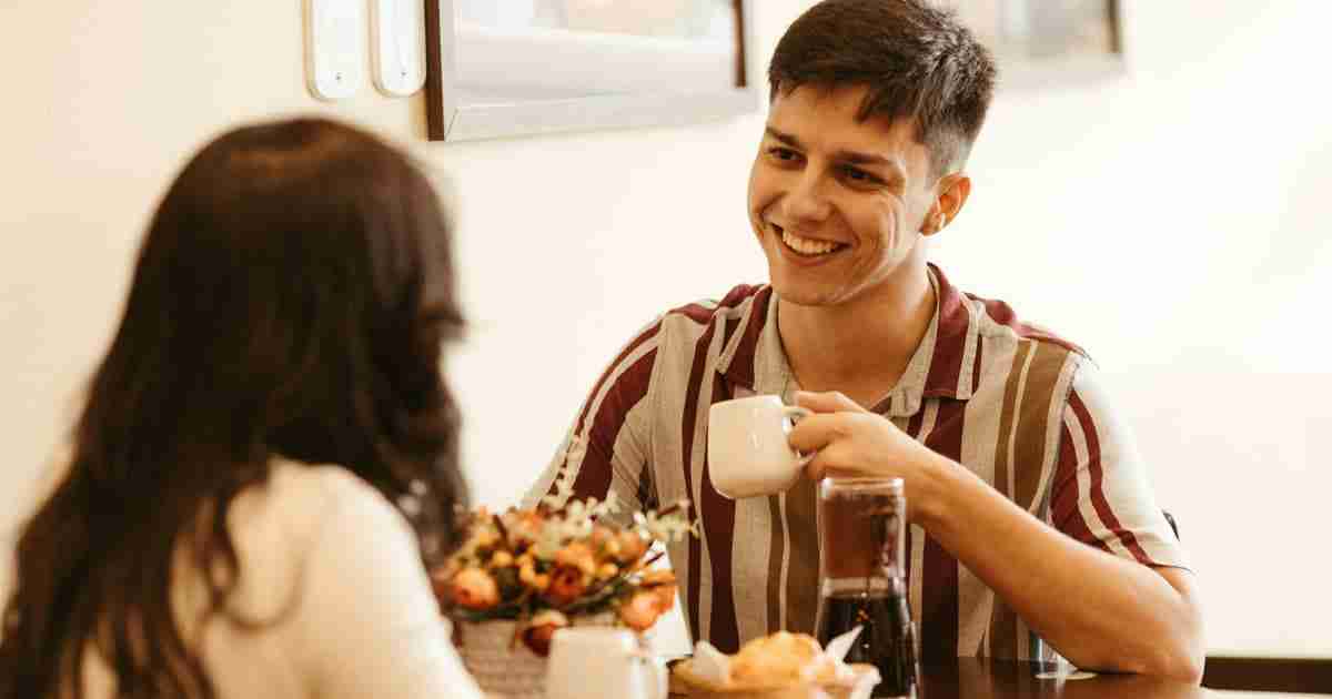 woman and man talking and drinking coffee together