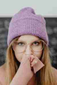 Young woman with hand over her mouth