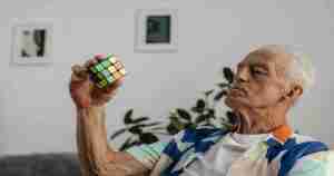 old man confused by Rubik's cube