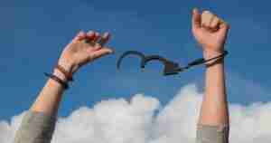 unlocked handcuff on wrist representing freedom and hope