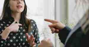 man pointing his finger at his wife