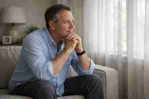 contemplative man sitting on sofa