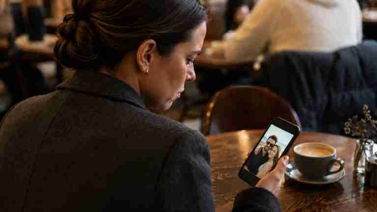 Woman looking at image of spouse and another on a phone