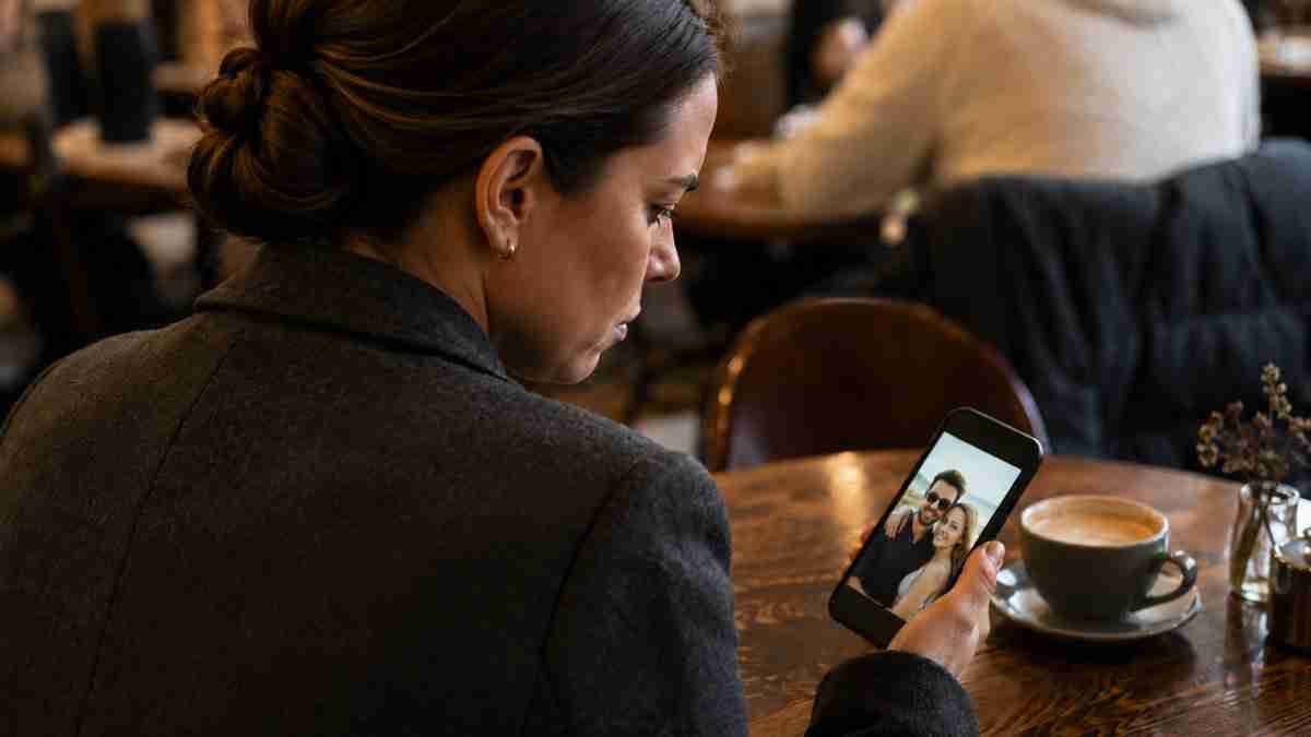Woman looking at image of spouse and another on a phone